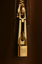 Via Essenza VIA backpack in dark brown Italian leather, Caffè color. Padlock with VE monogram in champagne-gold hardware.
