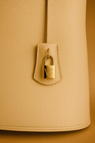 Via Essenza VIA backpack in soft beige Italian leather, Luminosa color. Clochette with padlock.