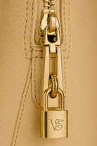 Via Essenza VIA backpack in soft beige Italian leather, Luminosa color. Padlock detail.