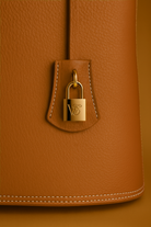Via Essenza VIA backpack in warm camel Italian leather, Terra color. Clochette with padlock.